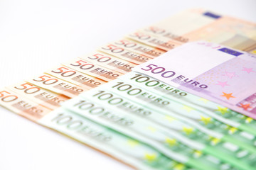 Euro banknotes close up. Several hundred euro banknotes on white background