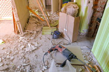 Drill on the dirty and dusty floor in a house under construction.