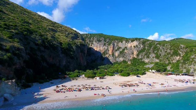 Summer Ionian Sea Aerial. coastline view with sandy beach on the sunset with green bushes in front, Albania dhermi gjipe beach.