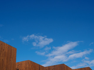 The tops of the buildings against the blue sky