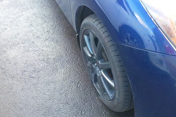 Part of the blue car on the wet asphalt, copy pastel