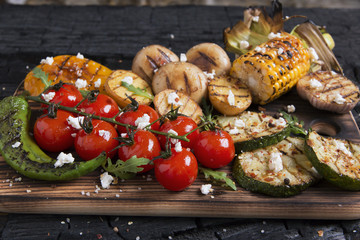 vegetable grilled tomatoes pepper paprika corn potatoes mushrooms on charcoal © koss13