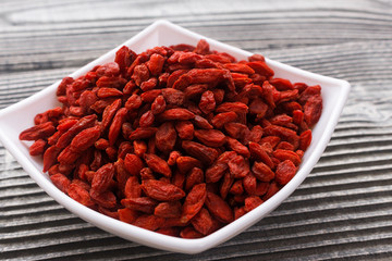 dried goji berries on a wooden rustic background
