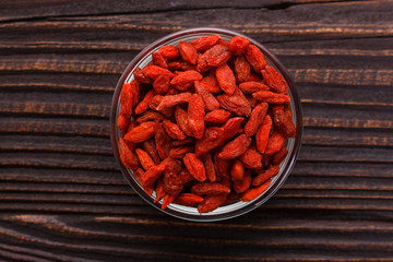 dried goji berries on a wooden rustic background