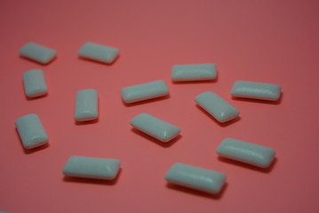 On the charcoal, peach paper are white cushions from chewing gum