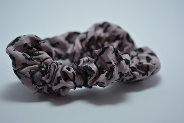 Female purple hair elastic band with black dots on a white background