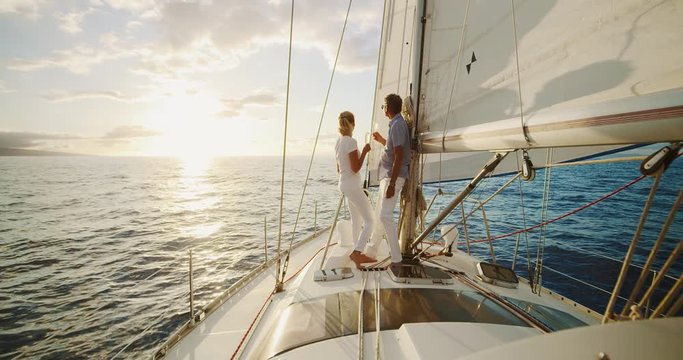 Middle aged couple celebrating life, sailing into the sunset