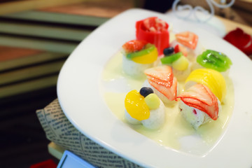 thai dessert: tropical mixed fruit coconut milk jelly on white dish