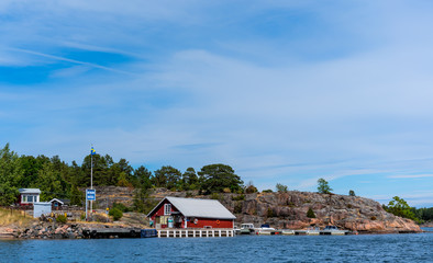 A gas station and some moored boats at a floating jetty in St. Anna archipelago in the Baltic sea, Sweden