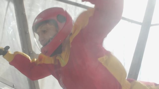 girl is floating in the air. flights in an aero tube. free fall and gravity in wind channel. preparation for skydiving