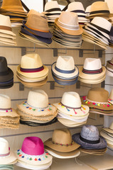 Many summer straw hats in shop