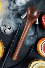 Obraz na płótnie Canvas Hookah Shisha With Smoke And Fruit Bowl Background