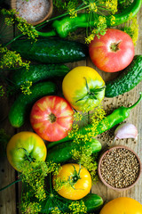 Procurement of Seasonal Vegetables Yellow Tomatoes Cucumbers Dill Pepper Garlic And Spices On A Wooden Background