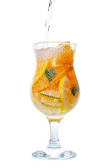 glass of pouring homemade lemonade with sliced fresh lemon, orange, lime, twig mint and bubble isolated white background
