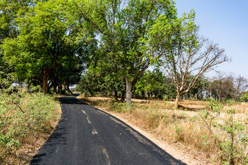 Fototapeta na wymiar close view of Newly made bitumen road at rural village looking awesome for village people.
