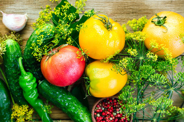 Procurement of Seasonal Vegetables Yellow Tomatoes Cucumbers Dill Pepper Garlic And Spices On A Wooden Background