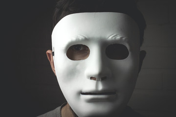 man in a white mask in the dark