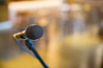 close up black standing microphone at convention hall in meeting education and business technology event concept