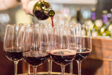 Filling glasses of red wine