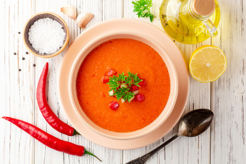 Gazpacho soup in bowl on white wooden background. Traditional spanish dish.