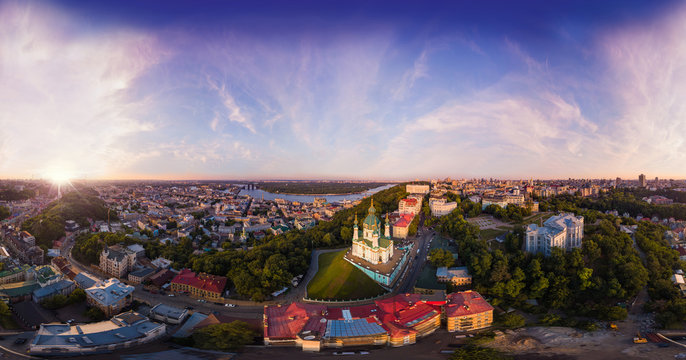 A big panorama of the city of Kiev on Podol at sunset. A modern metropolis in the center of Europe against the backdrop of sunset sky from a bird's eye view. Aerial view. Panorama of the Tourist