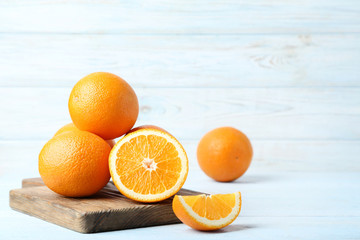 Orange fruit with cutting board on wooden table