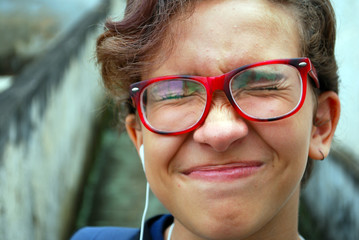 menina adolescente oculos vermelho cabelo curto em close, expressao expontanea brasil 2018
