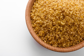 raw bulgur on a white acrylic background