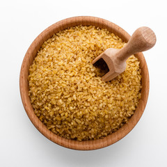 raw bulgur on a white acrylic background
