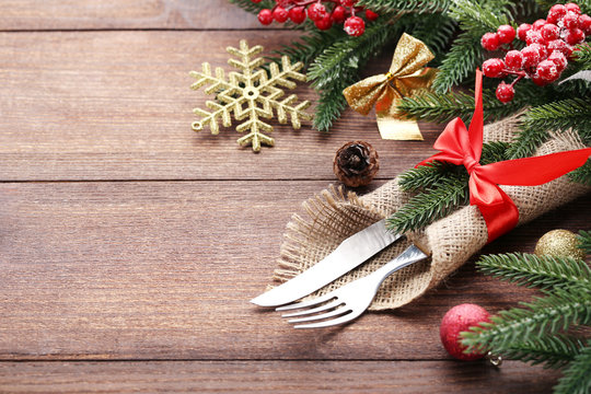 Kitchen cutlery with sackcloth and christmas decorations on wooden table