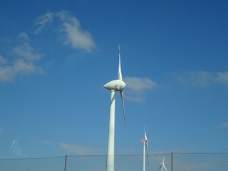 Wind generator against blue sky background