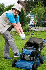 Middle-aged woman has problems using lawnmower