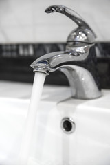 Water from the tap flows with a powerful jet