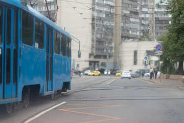 Fototapeta na wymiar a blue tram ride down the Street in Moscow
