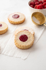 Obraz na płótnie Canvas Traditional Christmas Linzer cookies with sweet jam on plate, closeup, copy space.