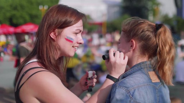 Girls get ready to cheer for Russian team in fan zone during football match