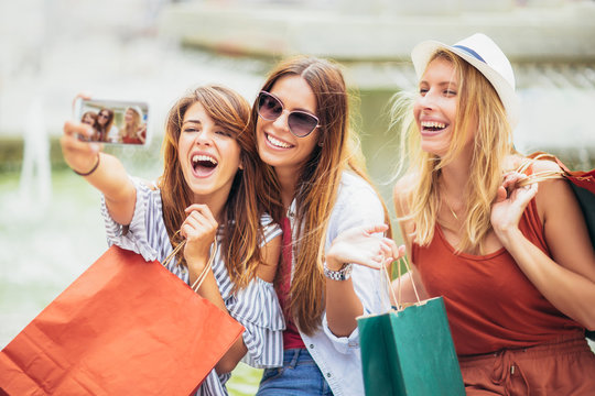 Three women shopping together and make selfie photo