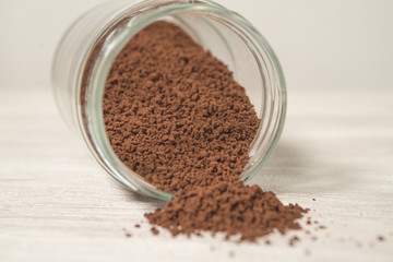 Obraz na płótnie Canvas Instant coffee granules scattered brown close up.