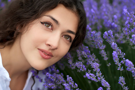 young woman is in the lavender field, beautiful portrait, face closeup, summer landscape