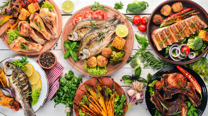 A set of food. Steak, Fish, Vegetables and Spices. On a wooden background. Top view. Copy space.