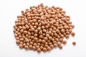 uncooked chickpeas on a white acrylic background