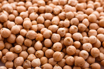 uncooked chickpeas on a white acrylic background