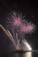 Fireworks from a pier in a marina