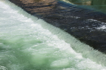 Flowing water of the Reuss river in the town of Bremgarten, Switzerland