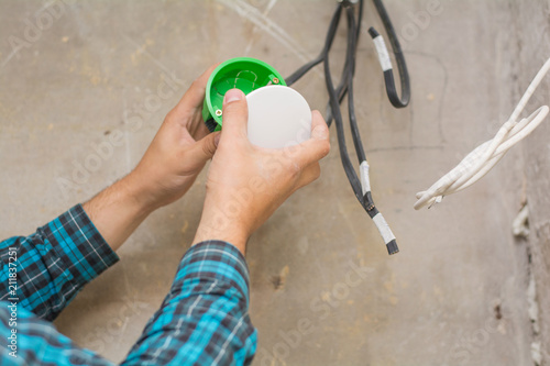 An Electrician Hand With Pliers During Install Mount Light