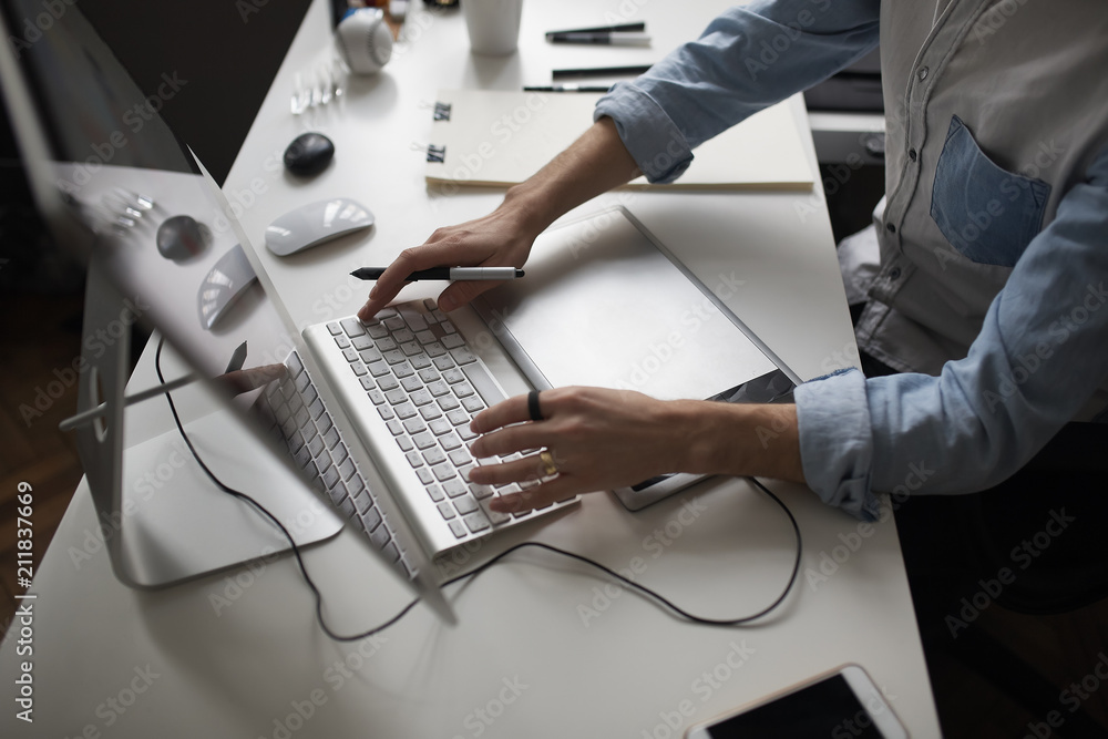 Fototapete male designer hands using graphics tablet while working with com