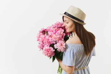 Young tender woman in blue dress, hat holding, sniffing bouquet of pink peonies flowers isolated on white background. St. Valentine's Day, International Women's Day holiday concept. Advertising area.