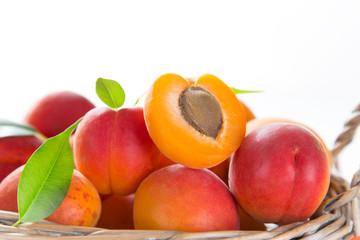 Naklejka na ściany i meble Fresh apricots on a white wooden background.
