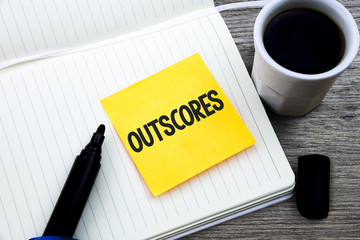 Handwriting text Outscores. Concept meaning Score more point than others Examination Tests running Health care Study material folder card register notebook pen cap tea coffee cup table.