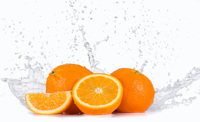 Fresh oranges with water splash over white background.